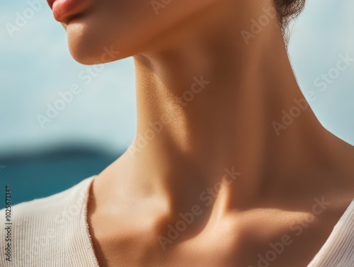 close up view of womans neck, showcasing smooth skin and elegant contours against blurred outdoor background. natural light highlights graceful lines, evoking sense of beauty and tranquility