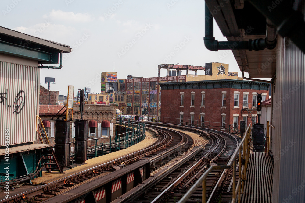 Fototapeta premium Subway train tracks curving through buildings in New York