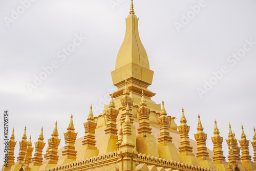 The diamond pinnacle of a beautiful great stupa made from gold is a famous tourist attraction in Vientiane, Laos that known as Wat Phra That Luang photo