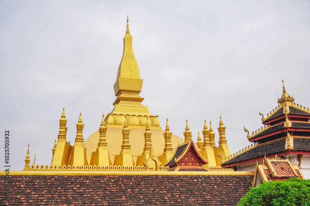 Naklejka premium A beautiful great stupa from outside view made from gold is a famous tourist attraction in Vientiane, Laos that known as Wat Phra That Luang