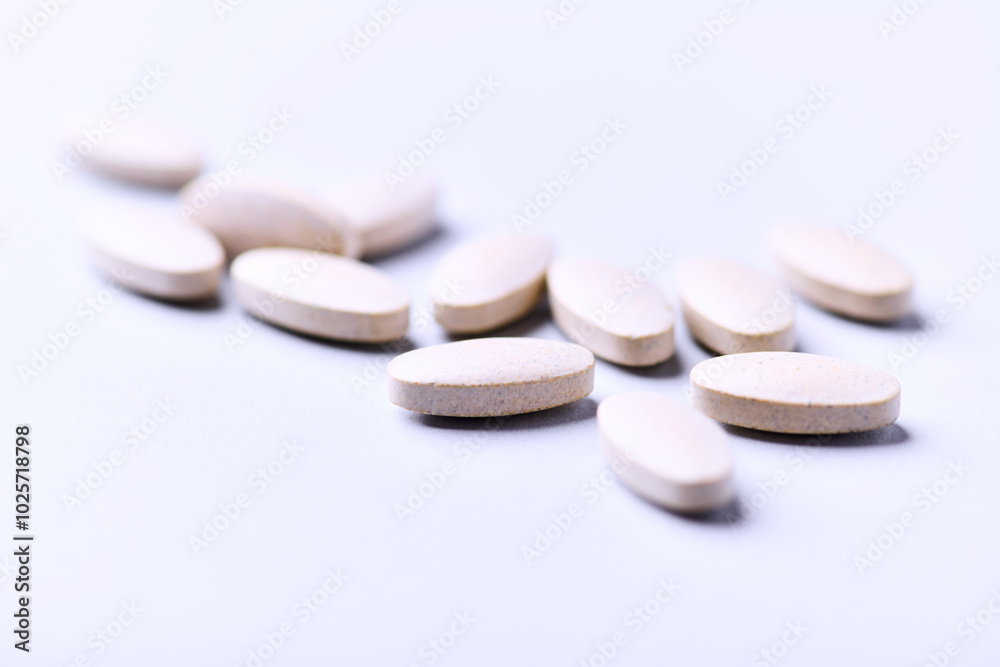 Ashwagandha (Withania somnifera) tablets. Concept for a healthy dietary supplementation. Bright paper background. Close up. Copy space. Ashwagandha (Withania somnifera) tablets. Concept for a healthy dietary supplementation. Bright paper background. Close up. Copy space.