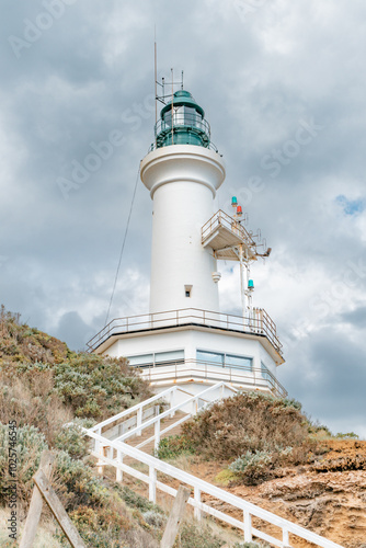 Point Lonsdale Lighthouse on hill with white stairway stormy sky photo