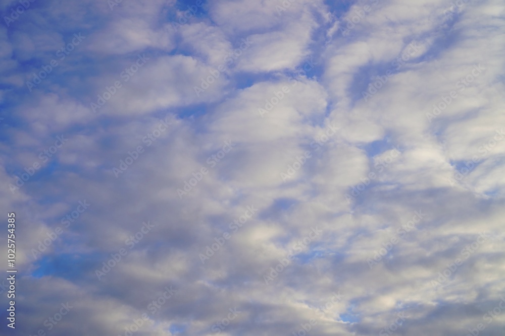 white fluffy clouds on a blue spring sky as backgrounds and screensavers for your phone and computer