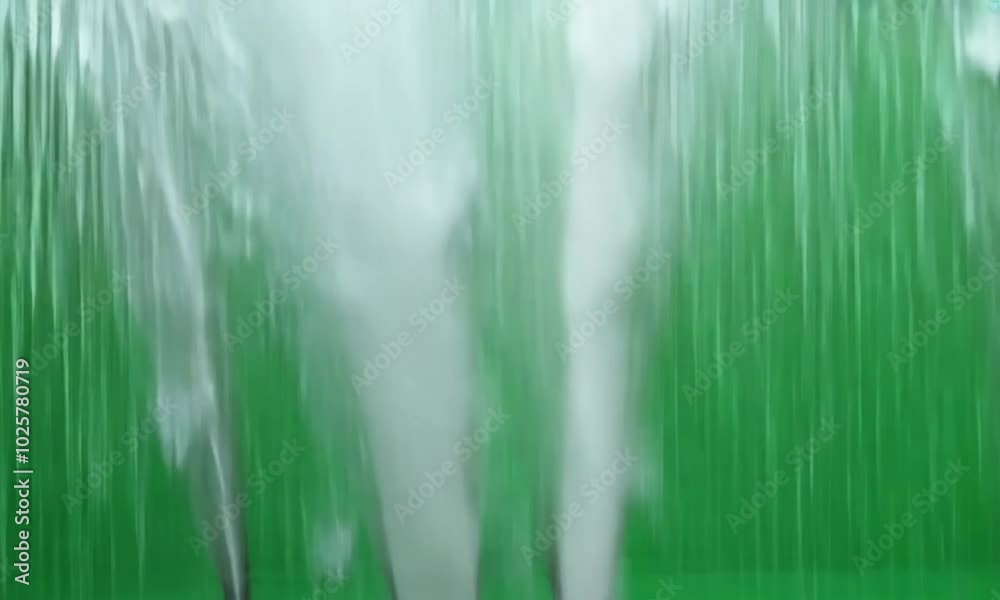 A heavy downpour of rain with gusts of wind blowing the water sideways ...