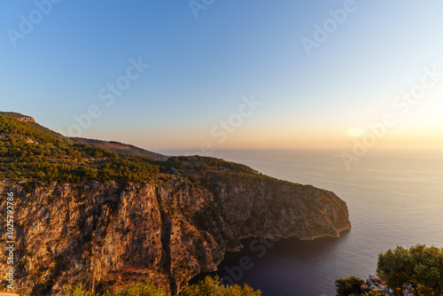 Breathtaking Sunset Over Calm Mediterranean Sea and Rocky Coastline..