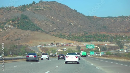 California highway with cars driving against a mountain backdrop in slow motion 120fps photo