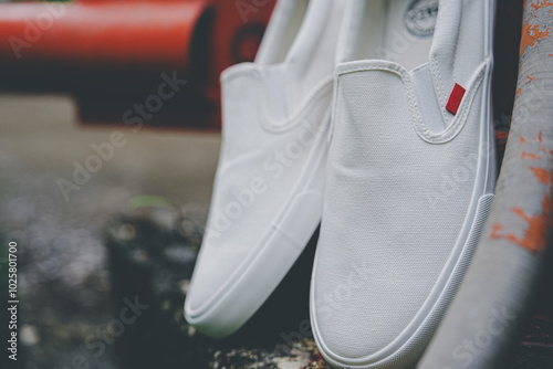 White canvas sneakers slip on men's footwear fashion shot outdoor.