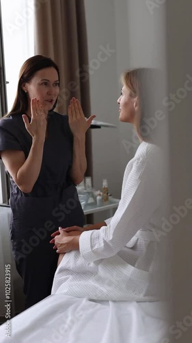 Consultation in cosmetology clinic. Female beauty doctor talking with patient. 