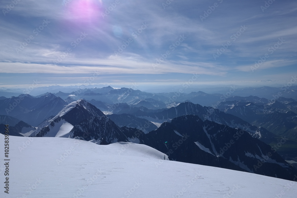 A stunning rock formation covered in snow, set against a clear blue sky with fluffy clouds in the background, creating a peaceful and breathtaking mountain landscape. A stunning rock formation covered in snow, set against a clear blue sky with fluffy clouds in the background, creating a peaceful and breathtaking mountain landscape.