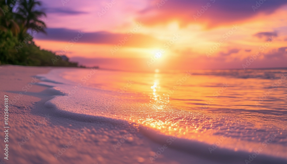 Fototapeta premium Tropical beach at sunset with light sand in the foreground.