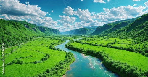 Lush green valley with a river winding through it, bright blue sky