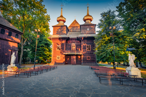 Attractive morning view of wooden Catholic Church of the Annunciation of the Blessed Virgin Mary. Wonderful summser cityscape of Tomaszow Lubelski town, Poland, Europe. Traveling concept background.