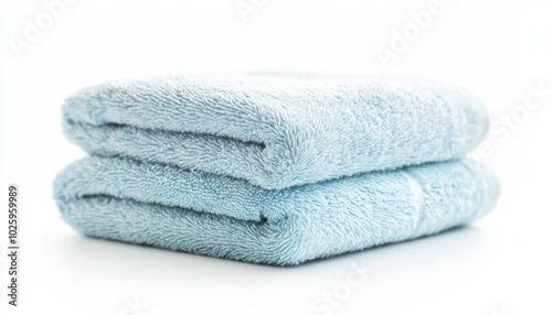 Two neatly folded light blue towels stacked on top of each other, showcasing a soft texture and a clean aesthetic.