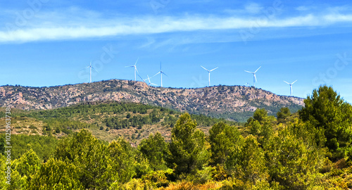 Mountains landscape. Wind turbine in mountains. Eolic park windpower. Wind farm, Wind green energy. Wind turbines, Windmill power generation in in Viver, Castellón, Caudiel, Spain. photo