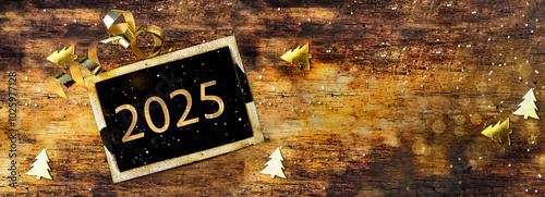 2023 written on  little board on rustic wooden background with golden confett...