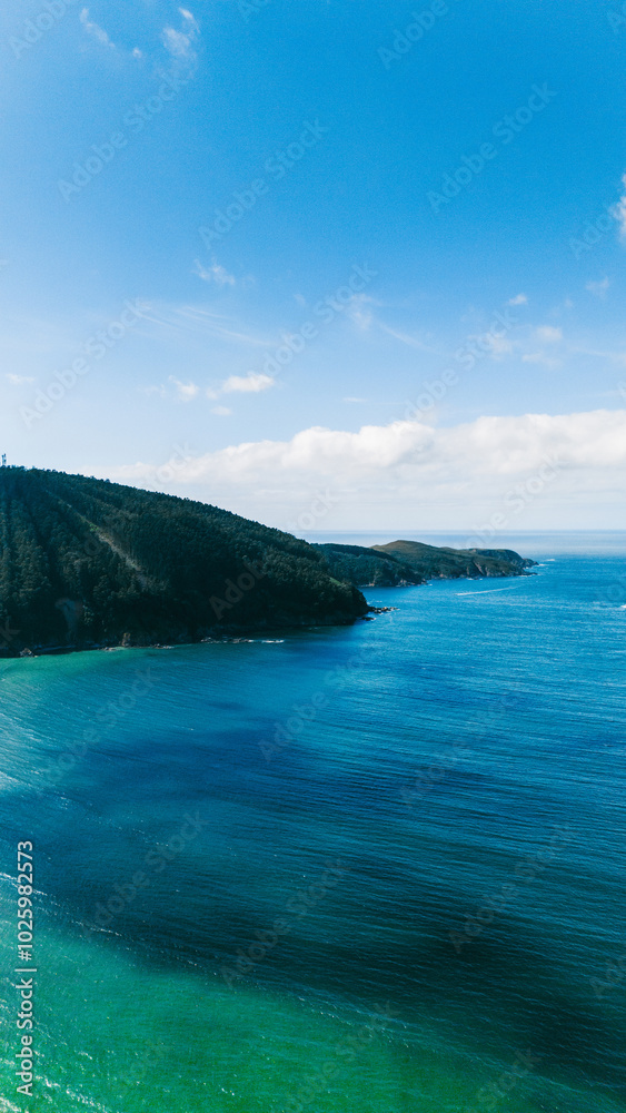 Aerial view of a lush coastline in Galicia with clear waters Aerial view of a lush coastline in Galicia with clear waters