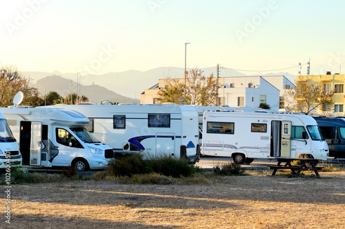 Motorhome area on Playa Casablanca. Campervan parking. Family rv camper van and Rving motorhome at sea. Traveling on Campervan along Spain coast. Caravaning Parking. Sept 02, 2023, Spain, Almenara.