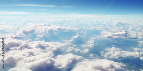 A celestial landscape of fluffy white clouds scattered across an expansive blue sky, a breathtaking view from above the world.