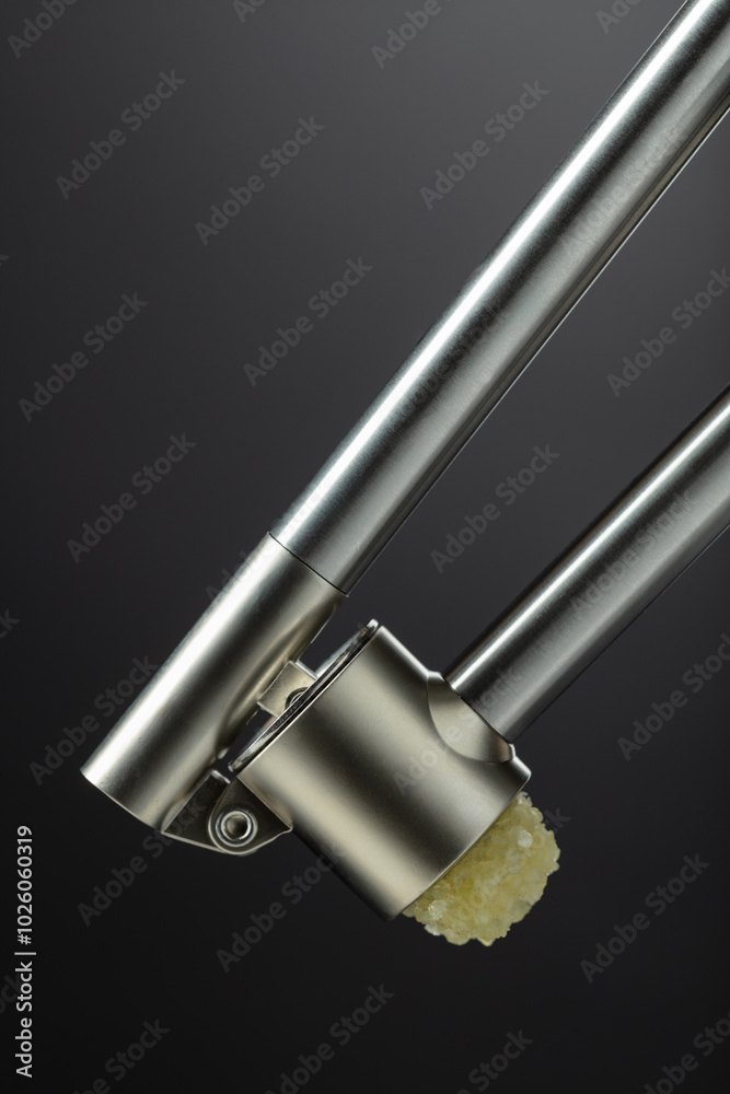 Garlic press on a black background. Garlic press on a black background.