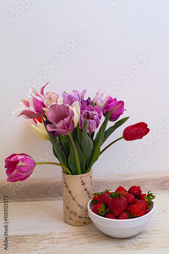 still life flowers in a vase and strawberries