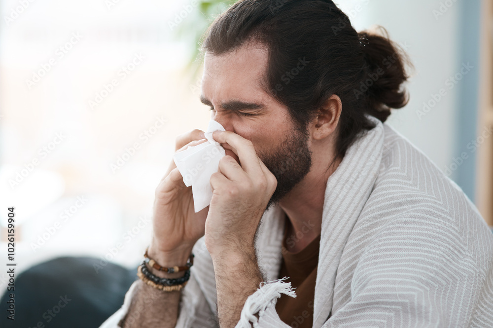 Man, tissue and blowing nose in home, allergies and living room for cold illness or influenza. Male person, corona virus and warm blanket for comfort in recovery, bacteria infection and hayfever Man, tissue and blowing nose in home, allergies and living room for cold illness or influenza. Male person, corona virus and warm blanket for comfort in recovery, bacteria infection and hayfever