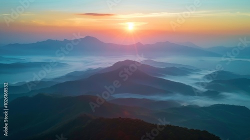 Sun Rising Over Misty Mountain Range