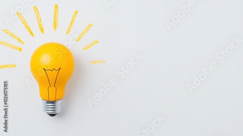 Yellow light bulb with drawn rays symbolizing idea and creativity on white background
