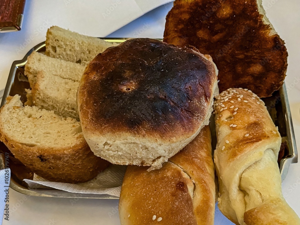 Several types of homemade bread lie on a tray