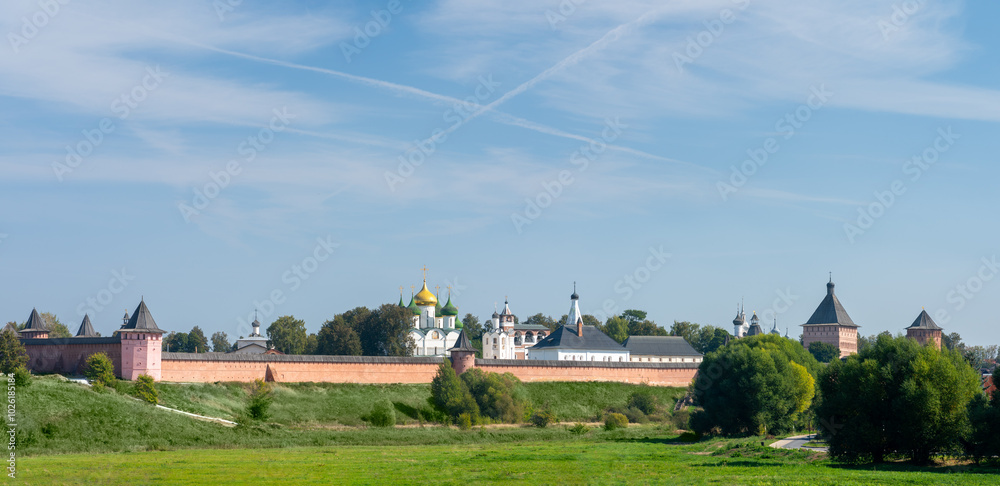 Suzdal Kremlin with fortified walls surrounding churches and buildings on a sunny day with blue sky. Golden ring city in Russia Suzdal Kremlin with fortified walls surrounding churches and buildings on a sunny day with blue sky. Golden ring city in Russia