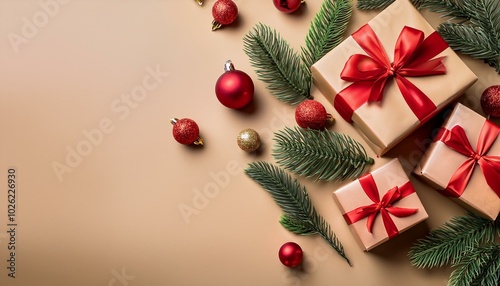 christmas gift boxes with vibrant red bows christmas ornaments and pine branches on a warm beige backdrop