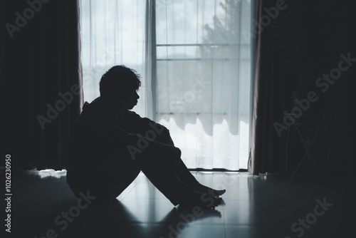 Silhouette of lost cast long shadow, embodying deep despair and hopelessness left him feeling perpetually stressed, sad, and unhappy. man sat alone, feeling weight of anxiety, stress, and depression.