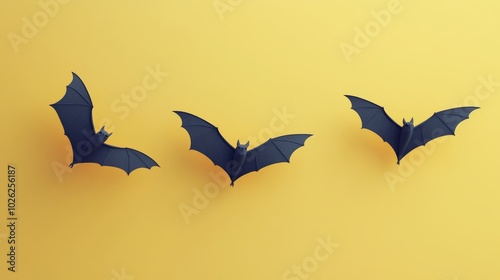 Bats flying against a vibrant yellow backdrop during Halloween-themed decorat...