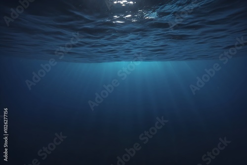 Underwater perspective of the ocean, capturing the play of light and shadows in the deep blue seascape.