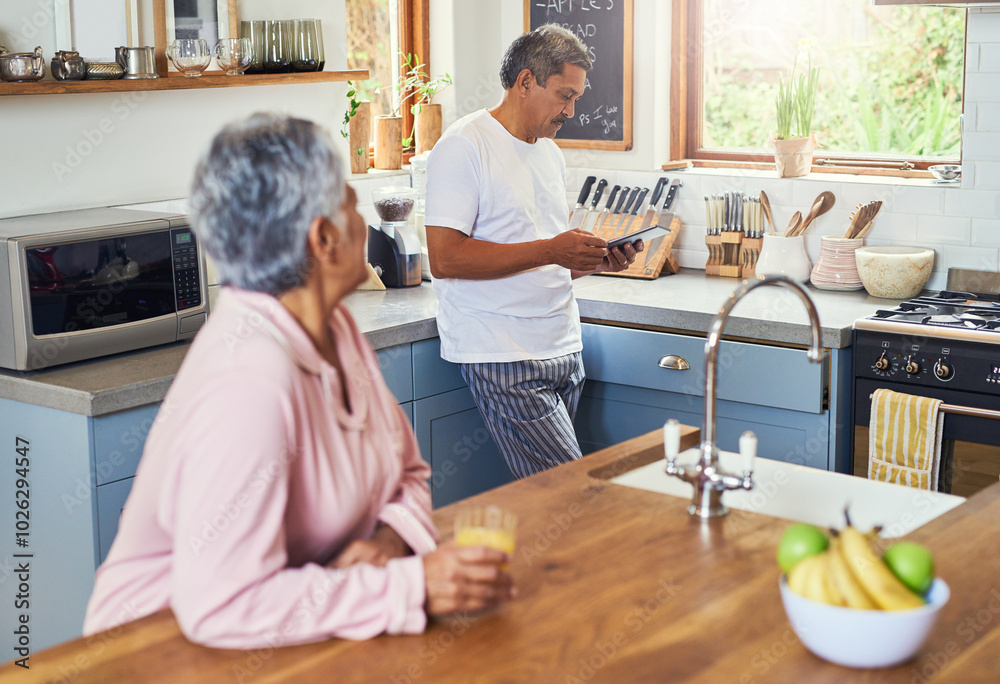 Fototapeta premium Senior man, tablet and old couple in home on social media, internet surfing or reading news. Retirement, elderly husband and woman drinking juice in kitchen with touchscreen for streaming on website