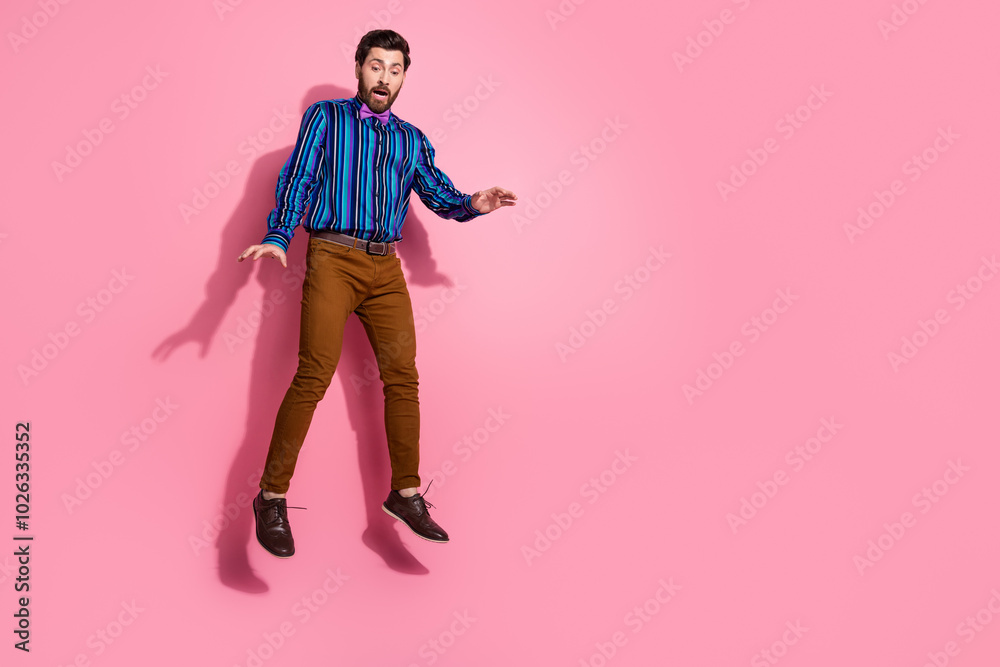 Full length photo of funny man wear stylish vintage clothes look empty space isolated on pink color background Full length photo of funny man wear stylish vintage clothes look empty space isolated on pink color background