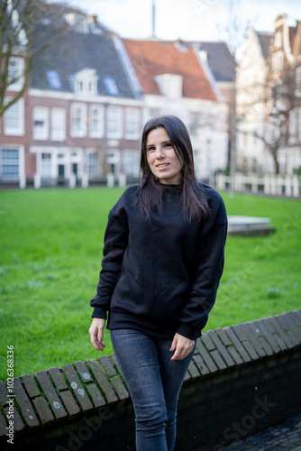 Young female tourist strolling through the Begijnhof in Amsterdam.