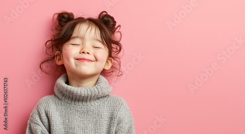 Happy Little cute Girl wear grey Knit sweater Smiling with Eyes Closed on Pink Background