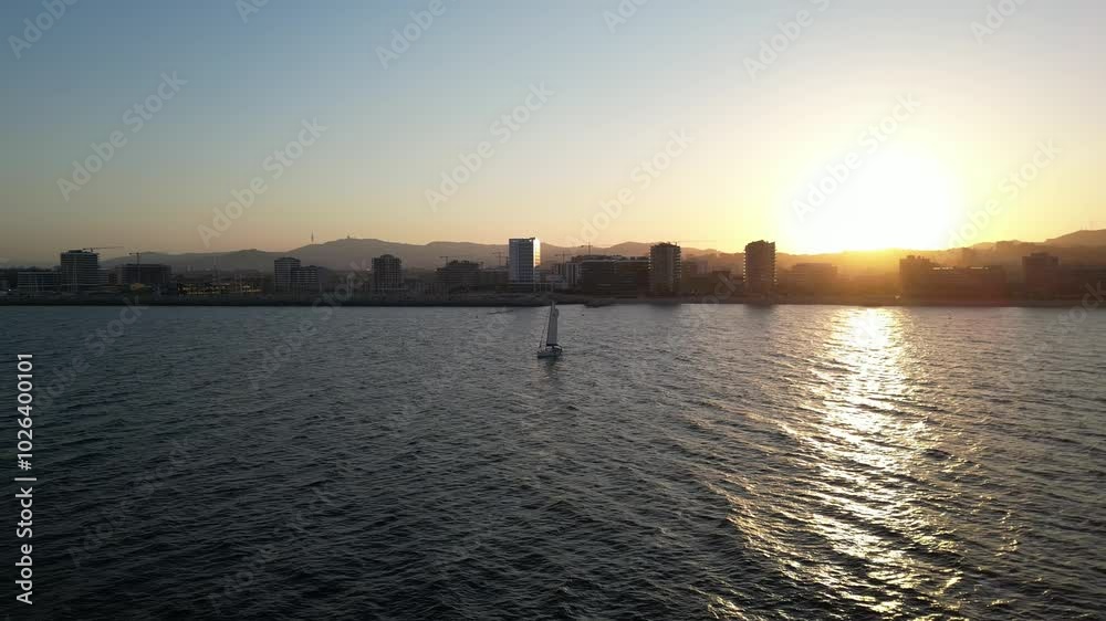 Aerial video of a yacht in the background of the coastline of Barcelona Spain Aerial video of a yacht in the background of the coastline of Barcelona Spain
