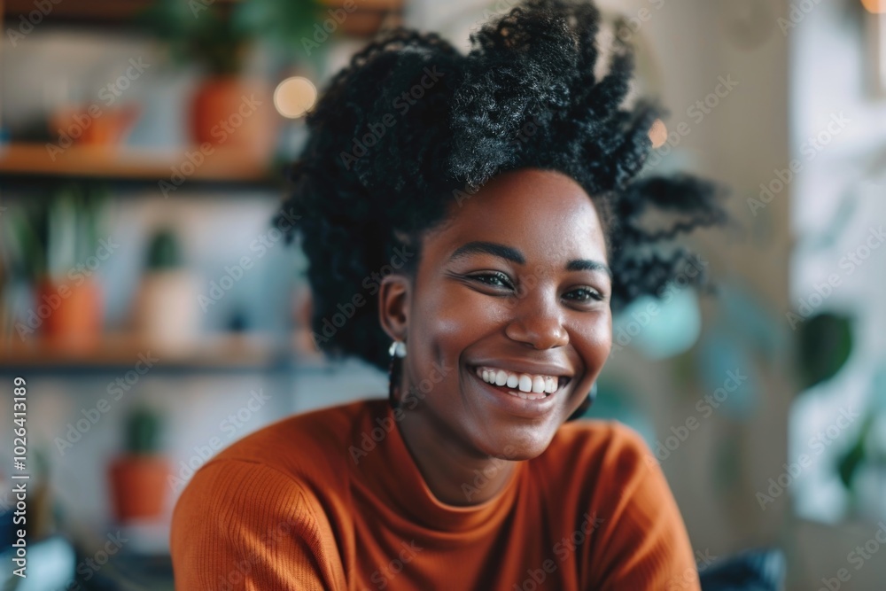 A smiling woman sits in front of a laptop computer, focused on her work A smiling woman sits in front of a laptop computer, focused on her work