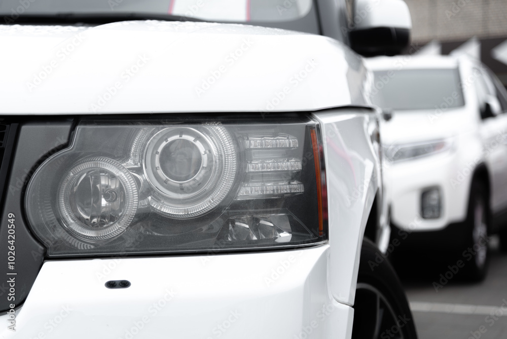 white car headlight, close up view, car dealing and manufacturing, cropped car image white car headlight, close up view, car dealing and manufacturing, cropped car image