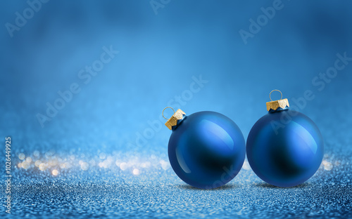 Christmas tree baubles on shiny glitter blue background with bokeh light. Festive winter holiday decoration and ornament. Modern design with copy space for greeting card, banner, invitation