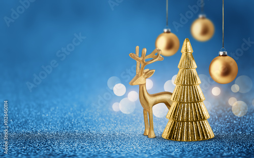 Gold deer, Christmas tree and bauble on shiny glitter blue background with bokeh light. Festive winter holiday decoration and ornament. Modern design with copy space for card, banner, invitation