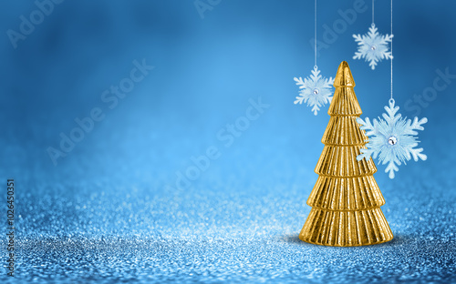 Gold Christmas tree and hanging snowflake on shiny glitter blue background with bokeh light. Festive winter holiday decoration and ornament. Modern design with copy space for card, banner, invitation