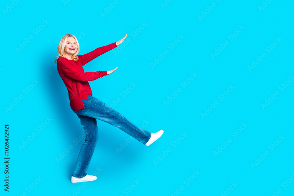 Fototapeta premium Full body photo of attractive retired woman dancing have fun dressed stylish red clothes isolated on blue color background