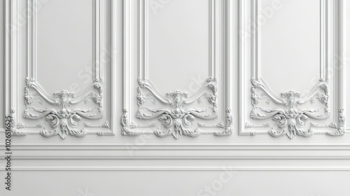 Elegant white wall decor featuring intricate moldings and blank frames in a s...