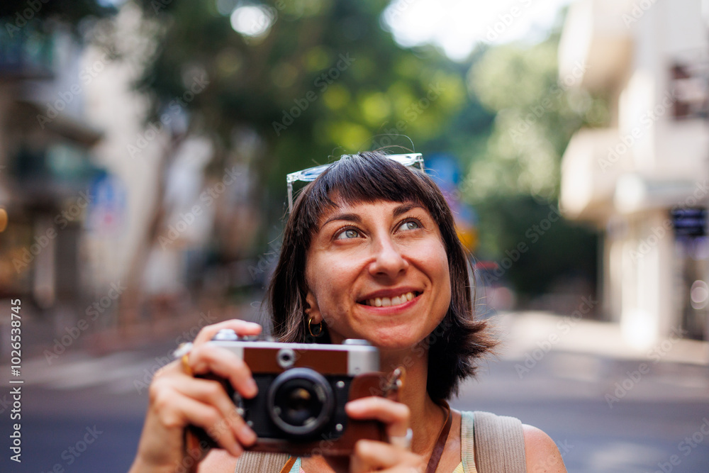 girl taking pictures. Girl walking around the city taking pictures with a camera. young girl with a film camera in the city. Close-up of a film camera. girl taking pictures. Girl walking around the city taking pictures with a camera. young girl with a film camera in the city. Close-up of a film camera.