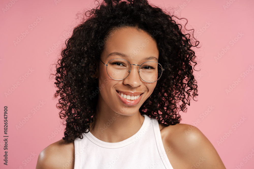 Close up of smiling African American woman in spectacles, looking at camera in studio Close up of smiling African American woman in spectacles, looking at camera in studio