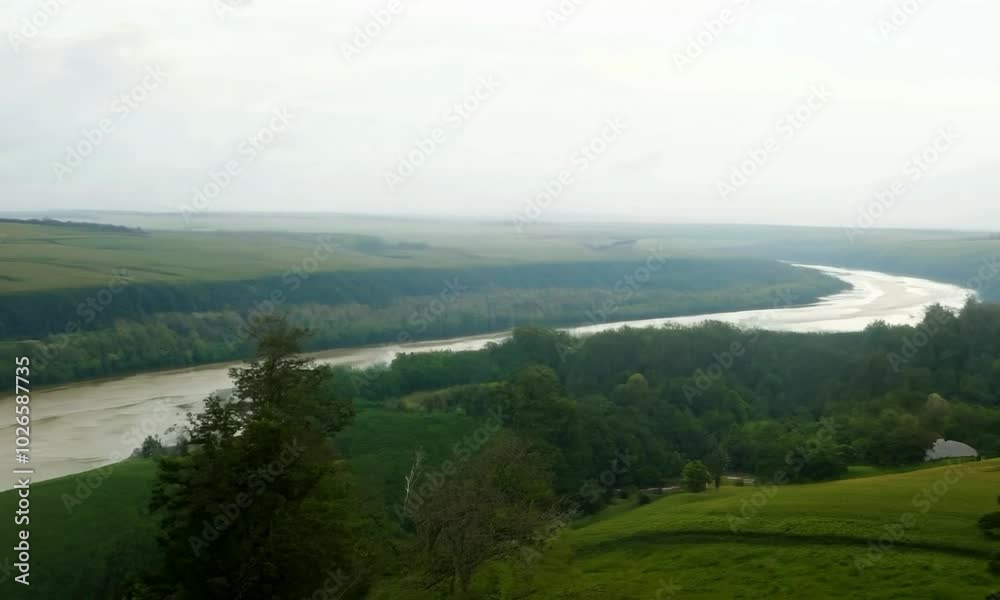 Pan shot with diffused daylight: The camera starts with a wide view of a serene countryside scene with rolling hills and a gently flowing river. The camera pans slowly, capturing the soft, diffused li Pan shot with diffused daylight: The camera starts with a wide view of a serene countryside scene with rolling hills and a gently flowing river. The camera pans slowly, capturing the soft, diffused li