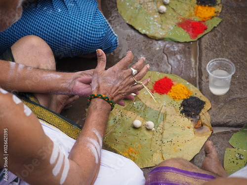 Close up of man hands doing puja ritual in Varanasi, India photo