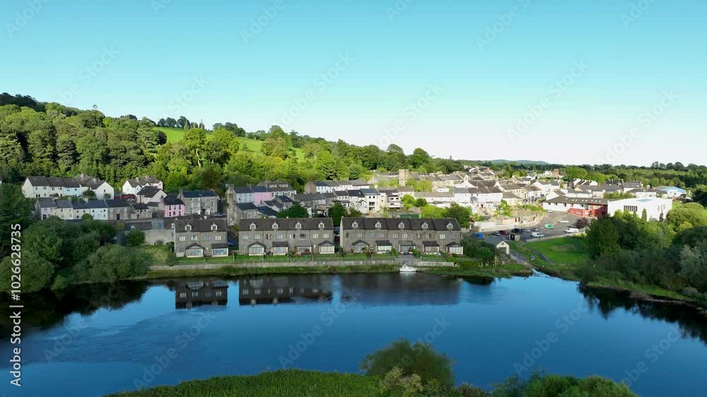 A serene aerial view of a picturesque town by a tranquil river A serene aerial view of a picturesque town by a tranquil river